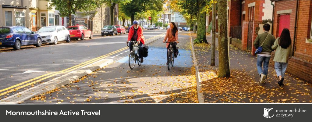 photo contains two cyclists and two walkers