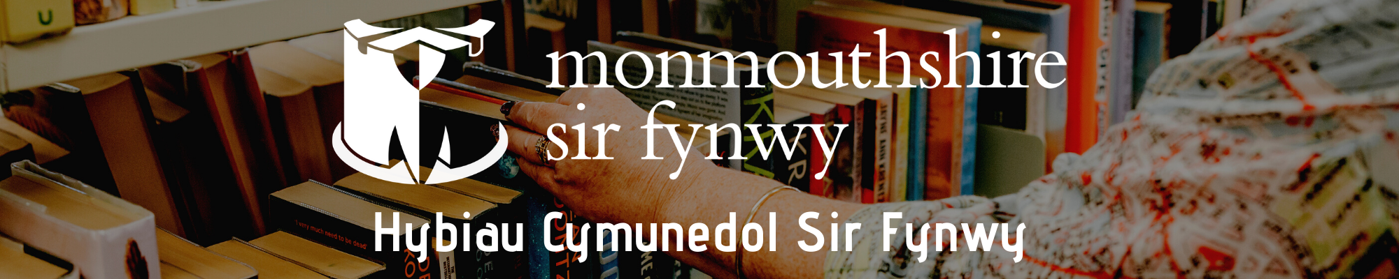 Photo of a library shelf with a ladies hand reaching for a book. ON top of the background picture is the monmouthshire logo with the text 'Hybiau Cymunedol Sir Fynwy'
