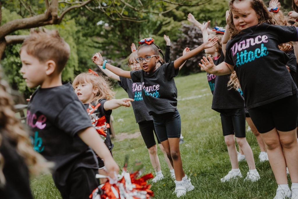 Children Dancing in a field to celebrate the Queen's Platinum Jubilee