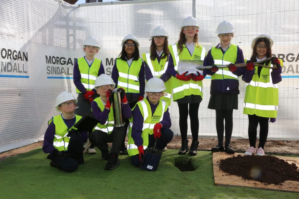 Deri View pupils in PPE with the time capsule