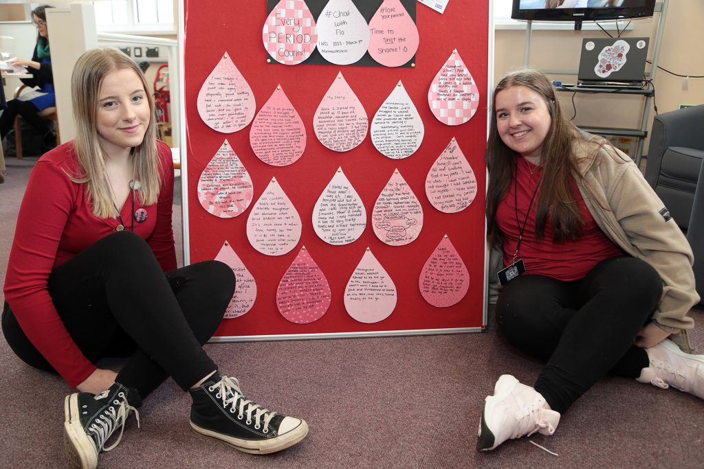 The Love Your Period campaign team with inspiring notes written by visitors to the event