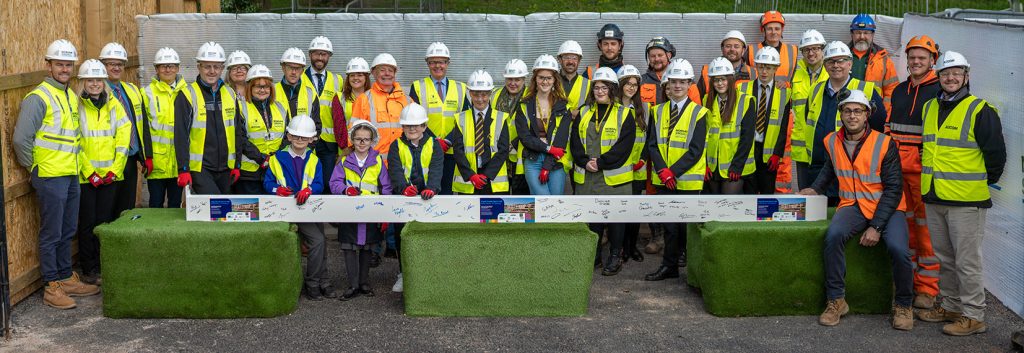 Everyone lined up by the steel on the site of the new through school in Abergavenny
