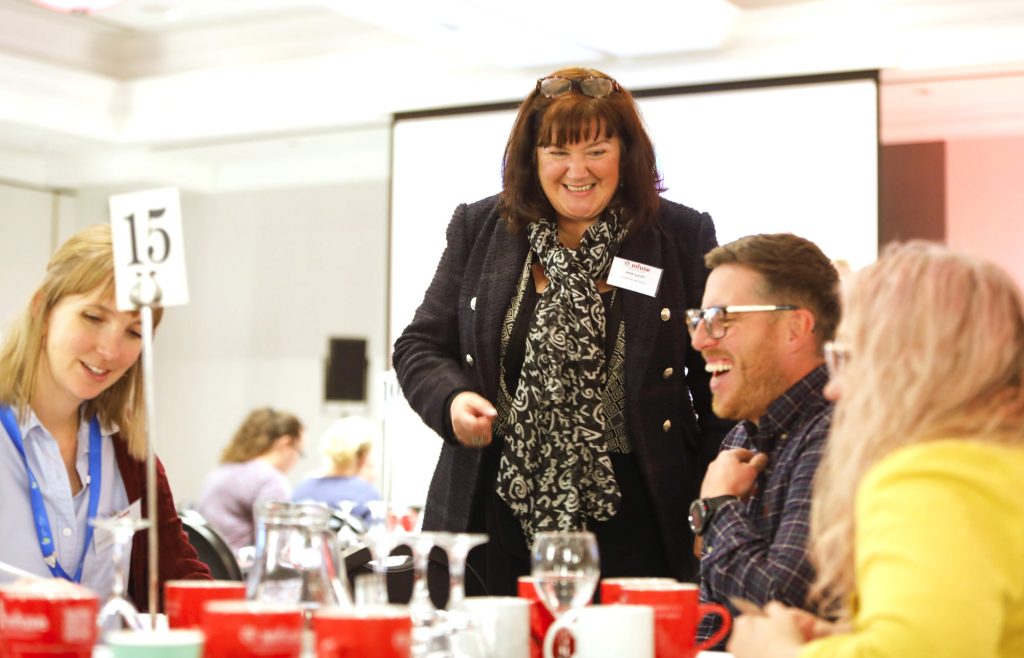 lady laughs with colleagues at event