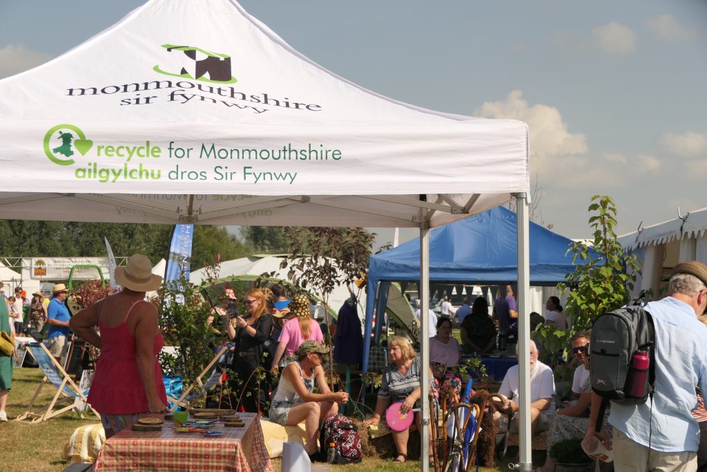 Monmouthshire County Council tent with visitors in the background 