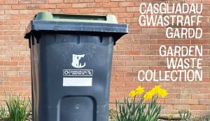 An MCC green garden waste bin, with the words - Green Waste Collection