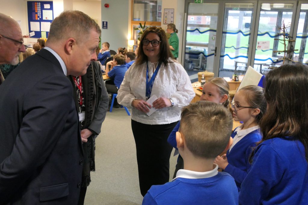 Minister for Education and Welsh Language Jeremy Miles MS speaking to pupils and Headteacher Mrs Bain